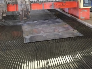 Water jet cut holes in sheet